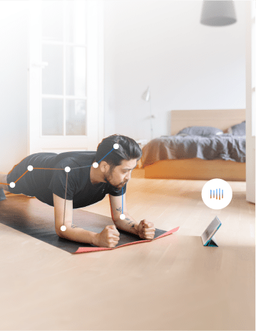 A man doing a plank on the floor, while looking at a tablet. Connecting lines are overlayed on his body aligning with joints and skeleton.