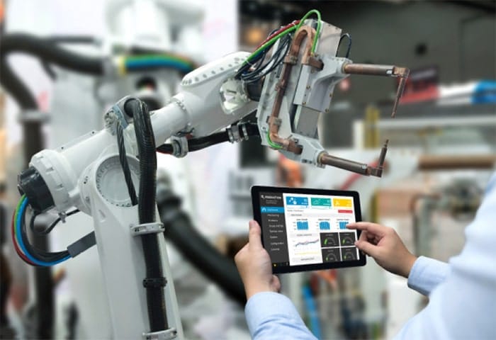 Holding a tablet, an operator selects and commands a cobot using the operator interface.